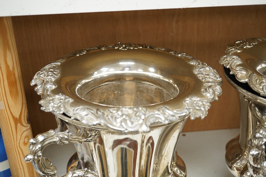 A pair of Old Sheffield plate two handled plated wine coolers, with later associated liners, 26cm high. Condition - fair